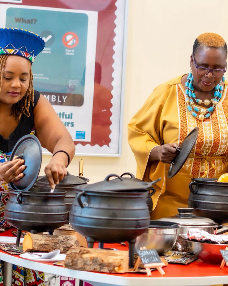 Our cooks preparing traditional dishes in potjie pots