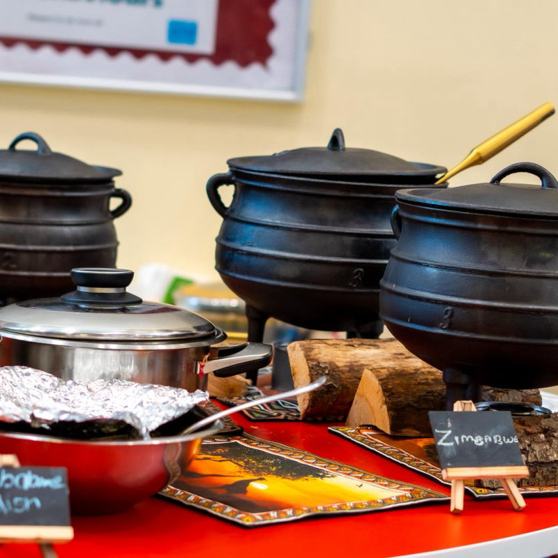 Traditional cast-iron pots at a serving station