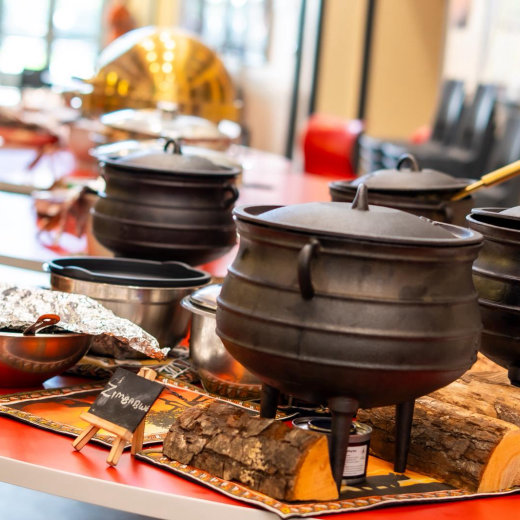 Cast-iron potjie pots on a serving station